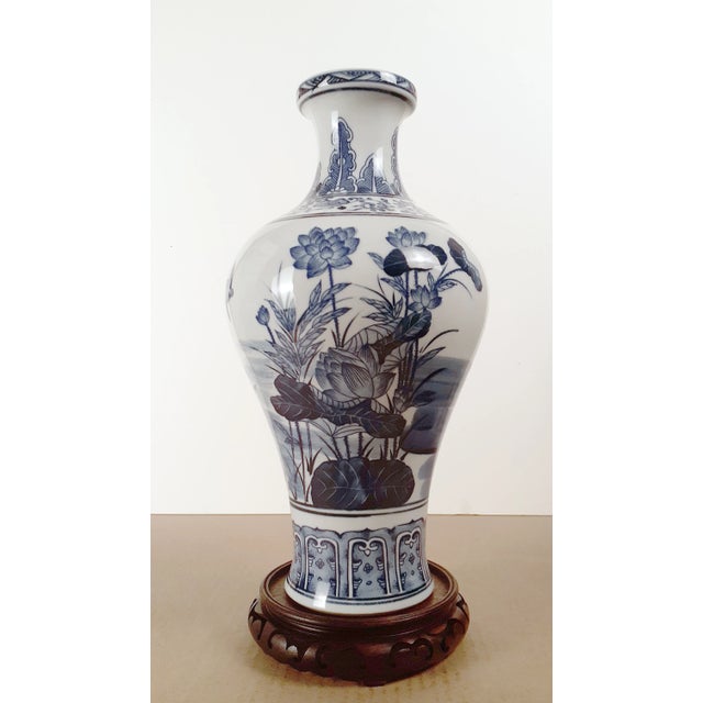 Chinese porcelain lotus pond fengweizun, with a blue and white glazed exterior and a white glazed interior and inset base....