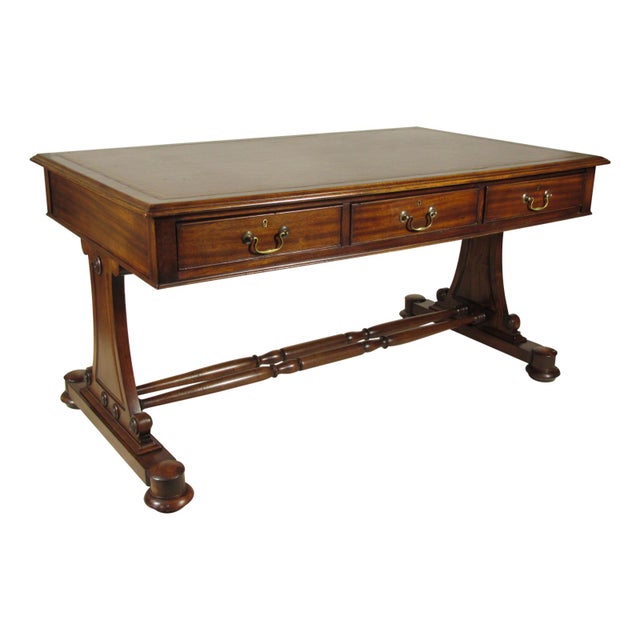 A Mid 20th-C. Regency-Style writing table with three frieze drawers, a tooled brown leather writing surface and solid...