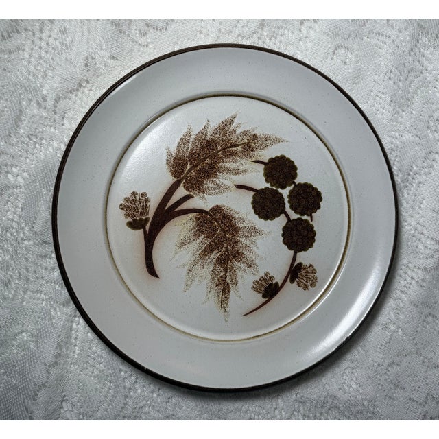 The Denby-Langley Cotswold Dinner Plate features a charming earthy design with a tan and brown plant illustration. Known...