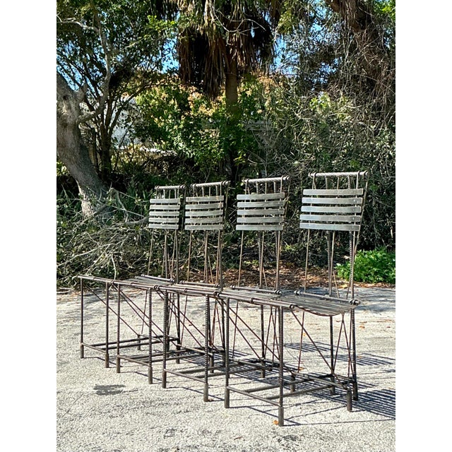 Elevate your interiors with this striking set of vintage Boho dining chairs, crafted with rebar construction and inspired...