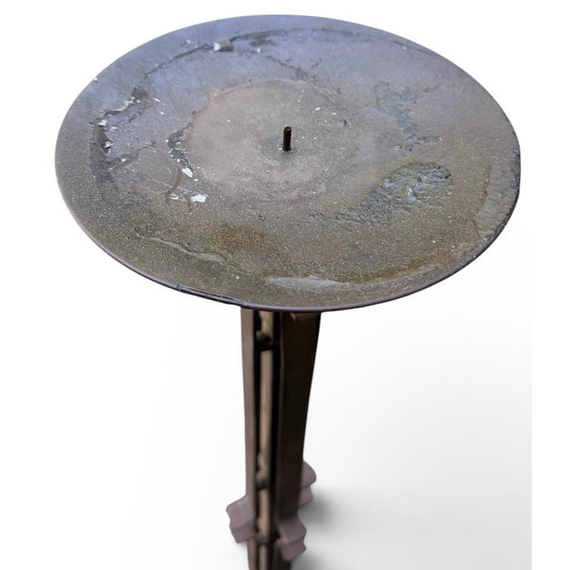 A striking pair of monumental, floor-standing wrought iron candle holders that bring an immediate architectural presence...