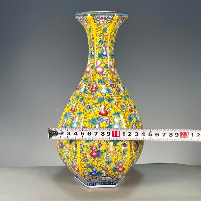 A beautiful Chinese yellow ground porcelain vase. This hexagonal vase features a pear shape and is finely hand-painted...