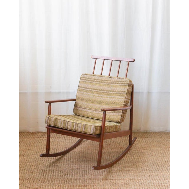 Clean-lined and quietly sculptural, this Edmond Spence–style rocking chair embodies the warmth and restraint of mid-...