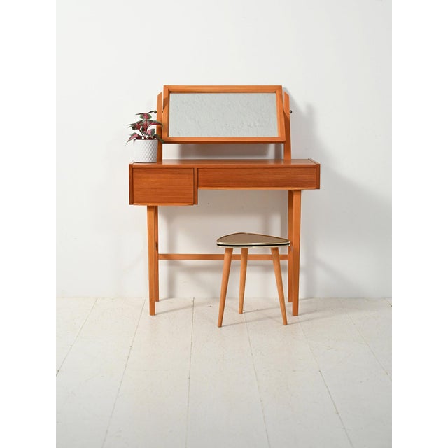 1960s Nordic teak dressing table, featuring clean lines, a swivel mirror, and drawers with an original jewelry divider....