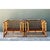 This vintage pair of lounge chairs is built from honey-toned rattan poles bent into low, boxy frames with softly rounded...