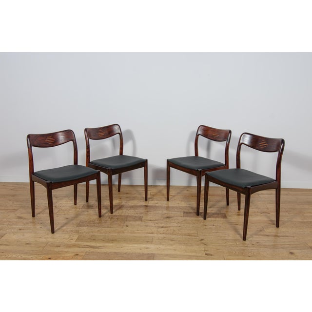 A set of four chairs manufactured in the 1960s by the Danish manufacturer Uldum Møbelfabrik. The contoured frame combines...