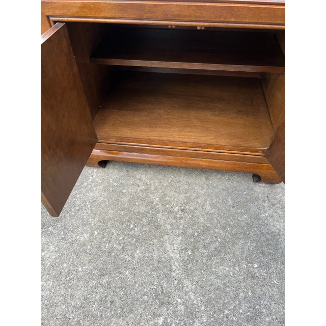 Pair of Chinoiserie Nightstands in a rich wood blended color with brass pulls and trimmed hinges . The interior has lots...