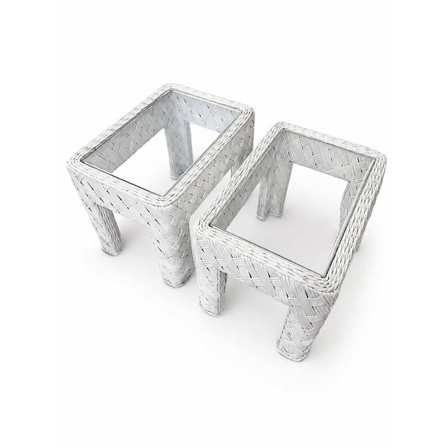 A sculptural pair of vintage woven-rattan side tables dating to the 1980s. Each table features a substantial rectangular...