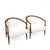 Modern mid century lounge chairs done in a cream leather upholstery. The chairs have a walnut finish. The chairs are circa...