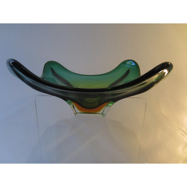 Mid-century classic from Murano: handmade, slightly irregular bowl made of Sommerso colored glass in vibrant green and...