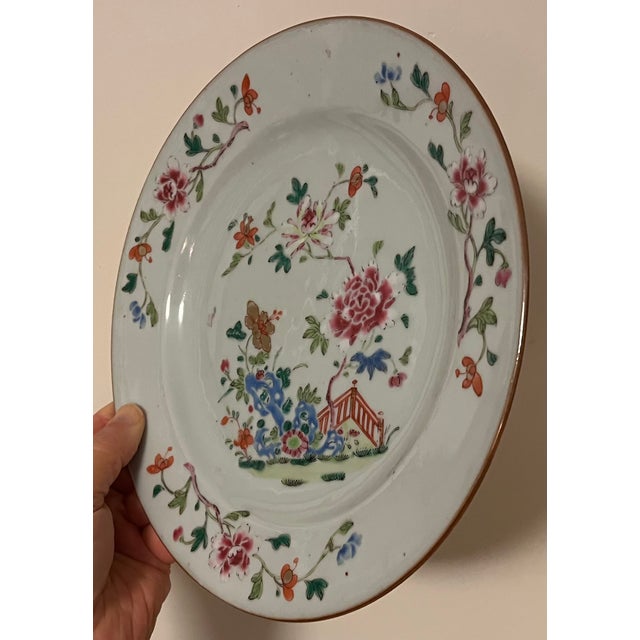 Antique 18th century Chinese export porcelain plate. Decorated in famille rose palette with peonies and a Chinese fence....