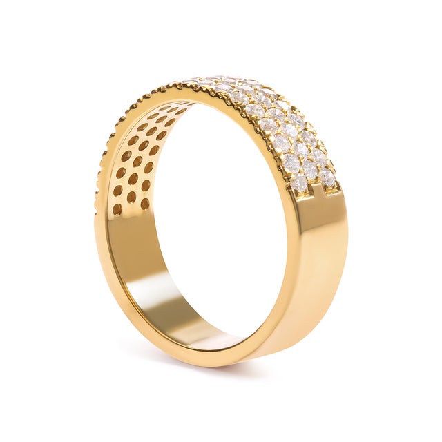 Indulge in the exquisite allure of this captivating diamond band ring, handcrafted in lustrous 14K yellow gold. This...