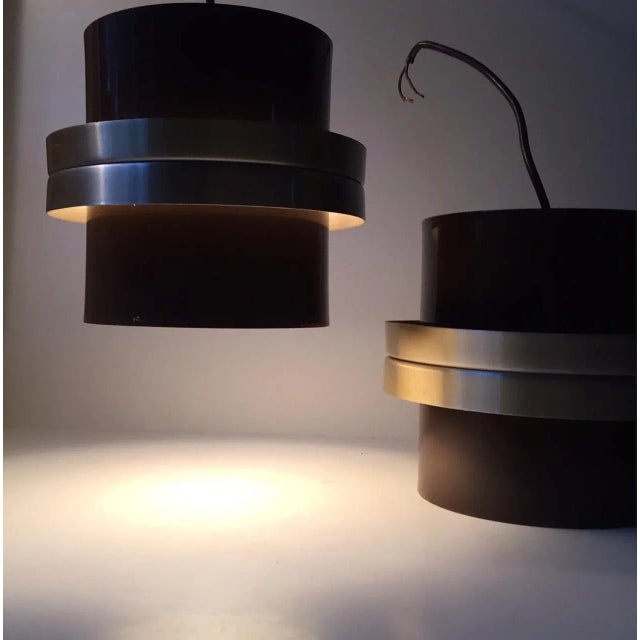 This pair of original colored (brown and brass) pendant lamps was designed by Carl Thore (Sigurd Lindkvist) and...
