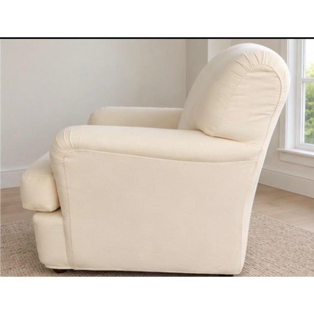 Quatrine Milan English Roll Arm Lounge Chair in Ivory Cotton Duck Quatrine Milan lounge chair featuring the brand’s...