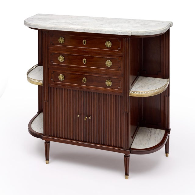 An elegant and unusual French Louis XVI style buffet/sideboard, circa 1880, finely crafted in mahogany and distinguished...