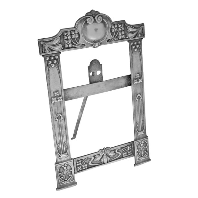 An elegant antique silver-plated picture frame in the Vienna Secessionist style, featuring clean lines and restrained...