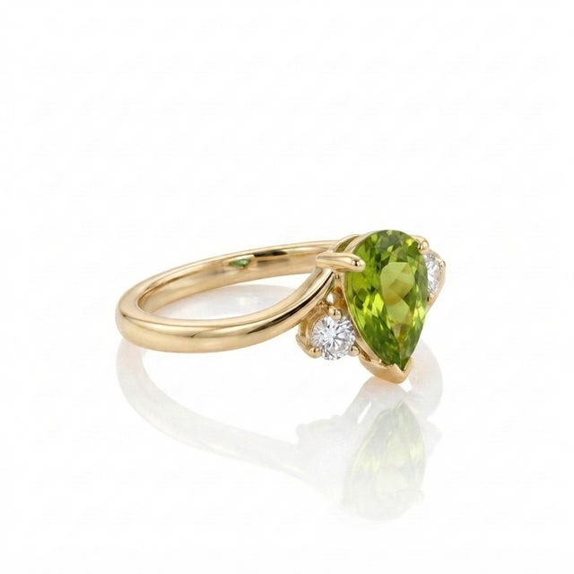 Celebrate the refreshing beauty of nature with this exquisite pear-cut peridot bypass ring. Featuring a striking lime-...
