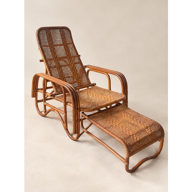 A striking mid-century rattan lounge chair distinguished by its sculptural bent frame, intricate woven surfaces and...