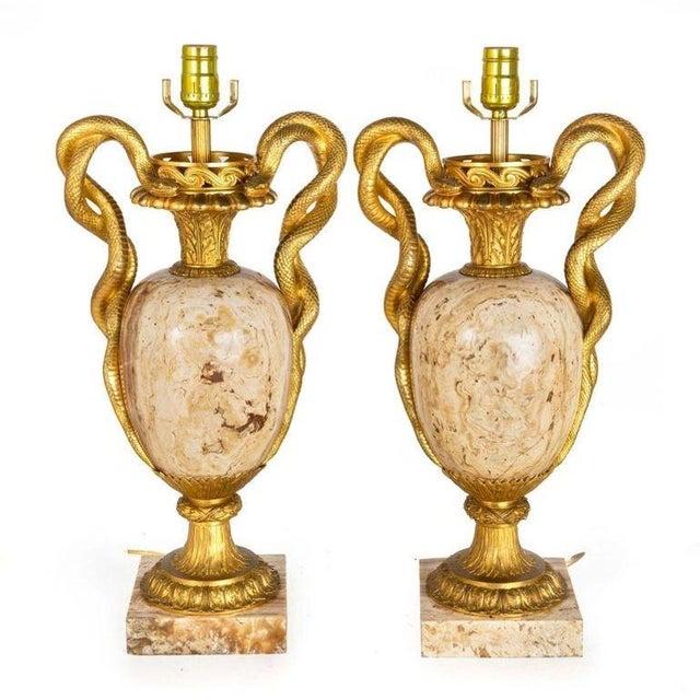 A truly stunning pair of vasiform lamps in the Louis XVI taste, they feature solid bodies crafted of a brilliant exotic...