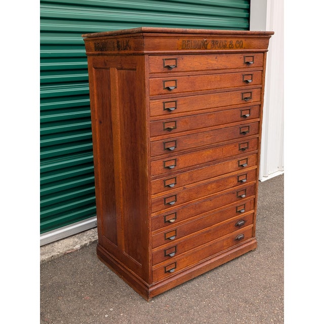 Fantastic, large spool / mercantile cabinet, thought to be an original store fixture. Oak construction with 12 pull out...