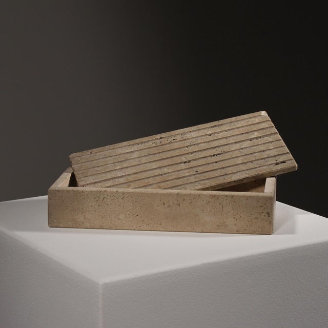 For sale is a minimalist lidded box made of solid travertine. The piece captivates with the characteristically grooved...