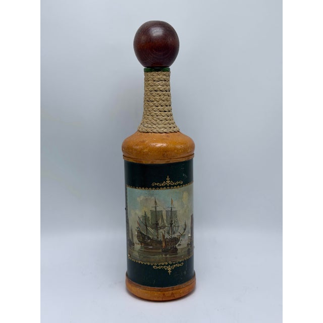 This is a handsome vintage Italian decorative bottle/decanter, crafted with a warm cognac-brown body and wrapped in deep...
