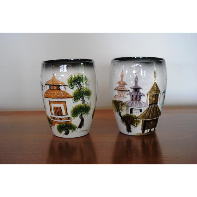Beautiful pair of California pottery vases by Sascha Brastoff. Done in colorful Asian village motif. Signed and marked on...