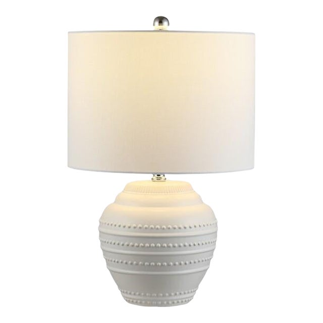 An elegant interpretation of ancient water vessels, this Lenon Ceramic Table Lamp is a new classic. Traditional textured...