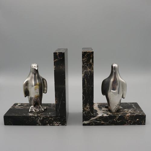 A pair of original art deco silvered bronze and marble bookends. Signed 'c. Omim' to each penguin. Dimensions: h 14.5cm w...