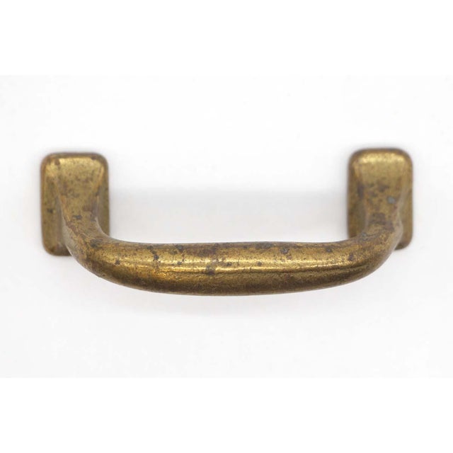 Classic style drawer pull with a slanted downward handle. It is made of cast iron with an antique brass finish. Screws are...