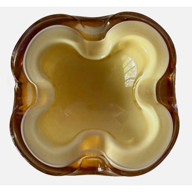 Vintage ashtray dish made of multicolor glass in the 1970s. This handmade piece showcases a tricolor sommerso glass...