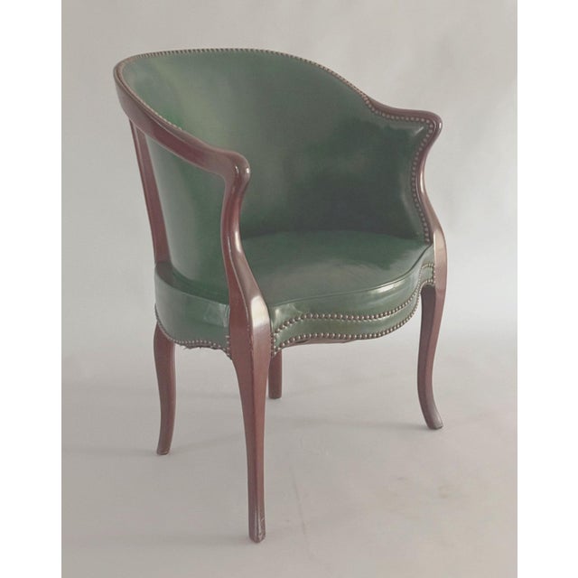 Antique Georgian tub back armchair with a continuous mahogany frame, upholstered in a dark green leather, a serpentine...