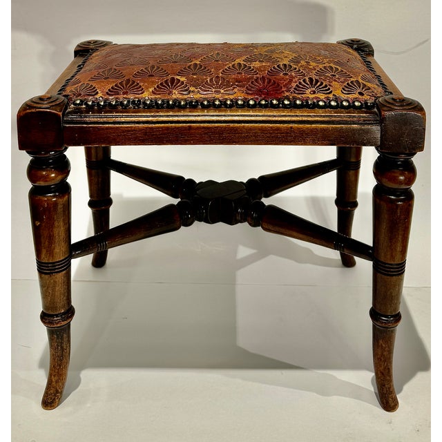 A handsome English Aesthetic Movement footstool dating to the late 19th century, featuring a richly patinated embossed...