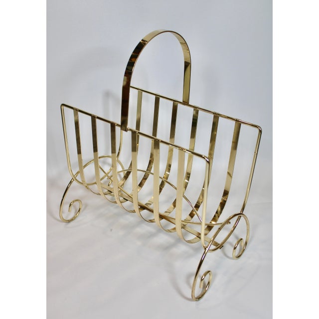 A charming bright lacquered brass magazine rack, circa 1960s. This is a lovely piece that will add an elegant touch to...