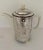 Art Deco, Bauscher Weiden porcelain coffee or tea pot fully insulated with felt in a hammered silver cozy by WMF. The...