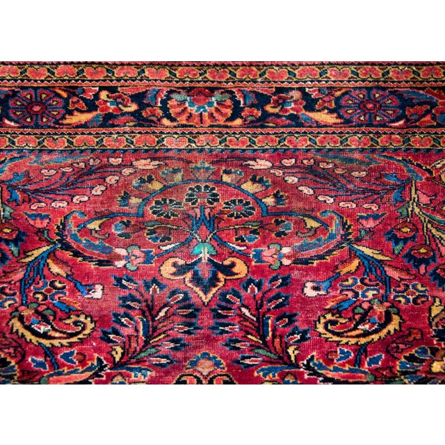 A beautiful early 20th century Persian Lilihan rug woven with a traditional mirrored floral pattern containing myriad...