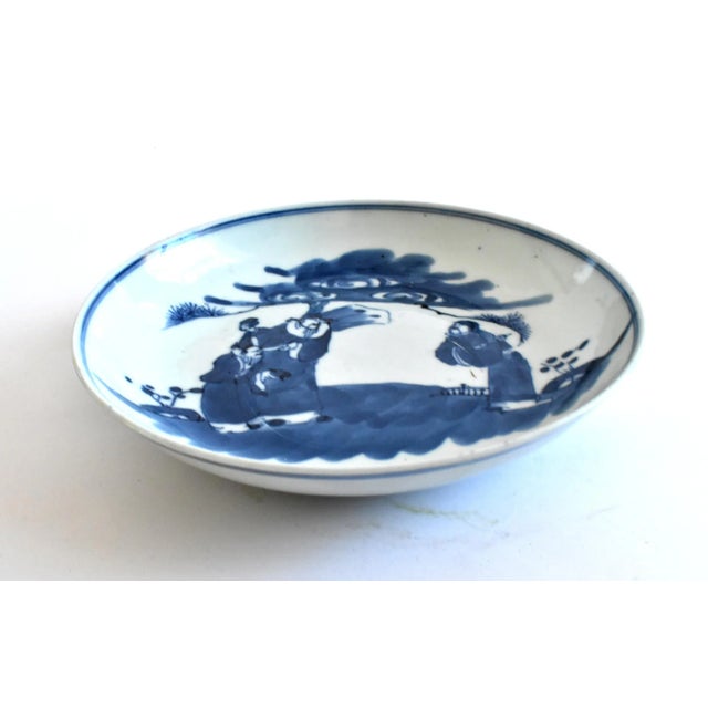 An antique, Qing Dynasty, Kangxi Period (1662-1722) plate, dish, or shallow bowl with cobalt blue underglaze with an...