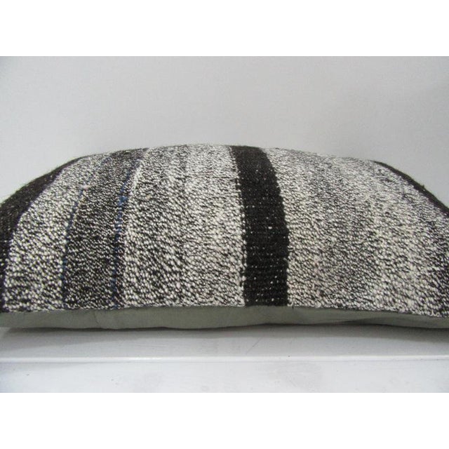 This is a pillow cover made from a vintage kilim rug. The piece was properly washed and ready to use. Pillow inserts not...