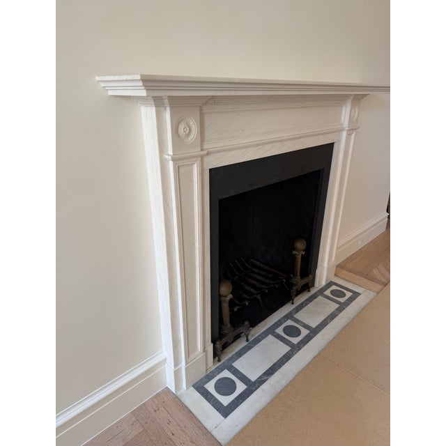 An exceptional Chesneys “The Langley” Regency period reproduction mantel in statuary marble, featuring elegant tapering...
