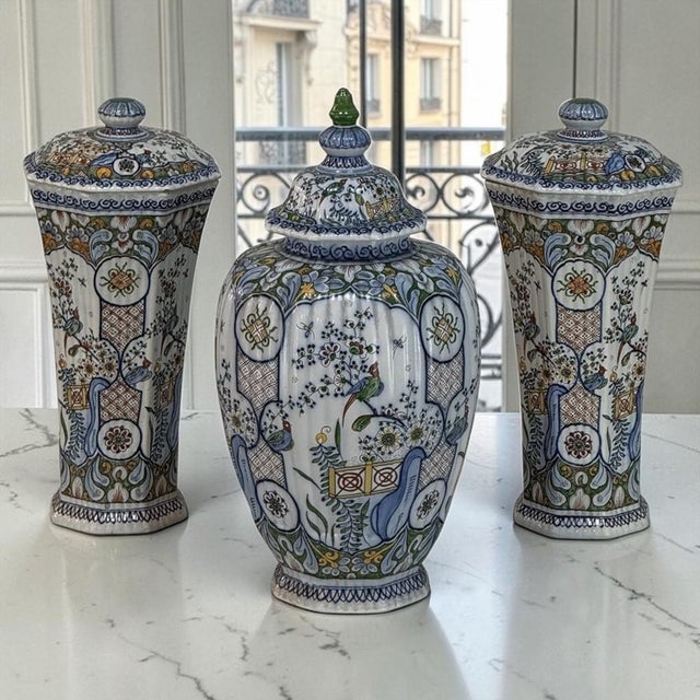 A striking set of three hand-painted ceramic lidded vases by Boch Frères Keramis, combining distinctive European...