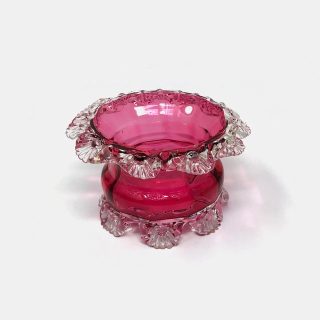 This antique French cranberry glass candle holder is in good condition as pictured with some small chips on the feet.