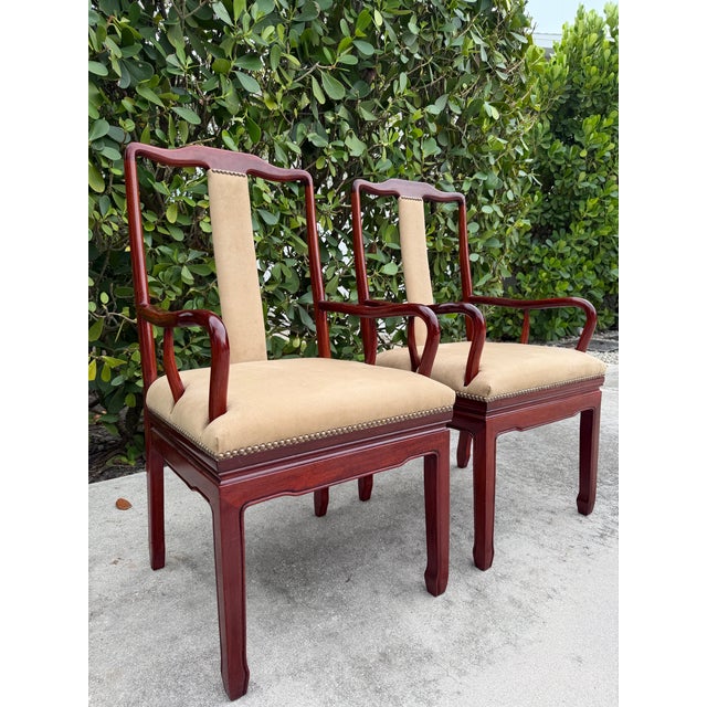 A handsome pair of Chinese Ming-style armchairs crafted in richly grained rosewood-toned hardwood. The chairs feature...
