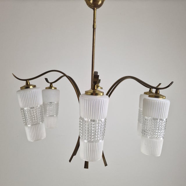 Striking and elegant Italian pendant lamp attributed to Mazzega, executed in Murano glass and brass during the 1970s. The...
