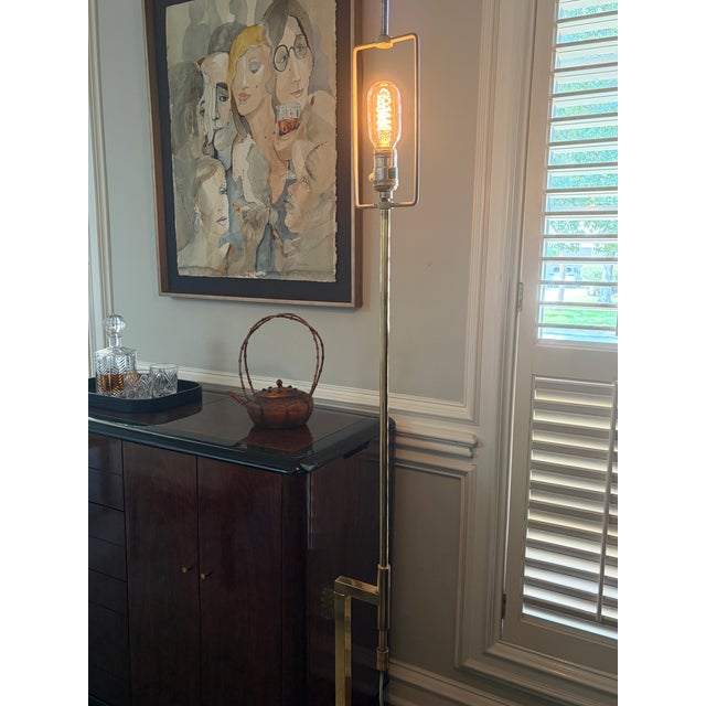 A striking Mid-Century Modern telescoping floor lamp featuring a beautifully architectural rectangular brass base,...