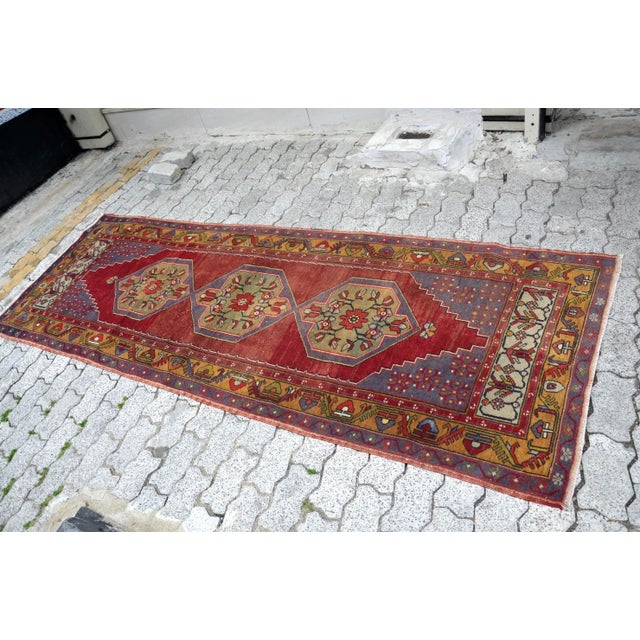 This is a vintage Turkish Oushak rug from the 1960s. The piece was hand-knotted.
