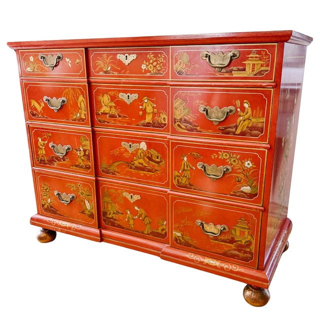 A fantastic 1960 red lacquer chest of drawers hand-painted with a Chinoiserie motif and pronounced curving drawer fronts....