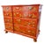 A fantastic 1960 red lacquer chest of drawers hand-painted with a Chinoiserie motif and pronounced curving drawer fronts....