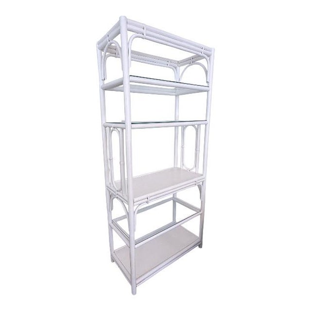 This stunning vintage rattan etagere is a timeless piece that blends coastal charm with classic sophistication. With a...