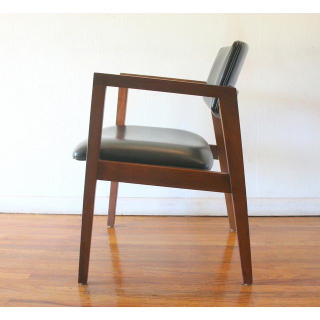 This is a mid century modern arm chair by United Chair Company. It has a solid wood frame with an upholstered contoured...
