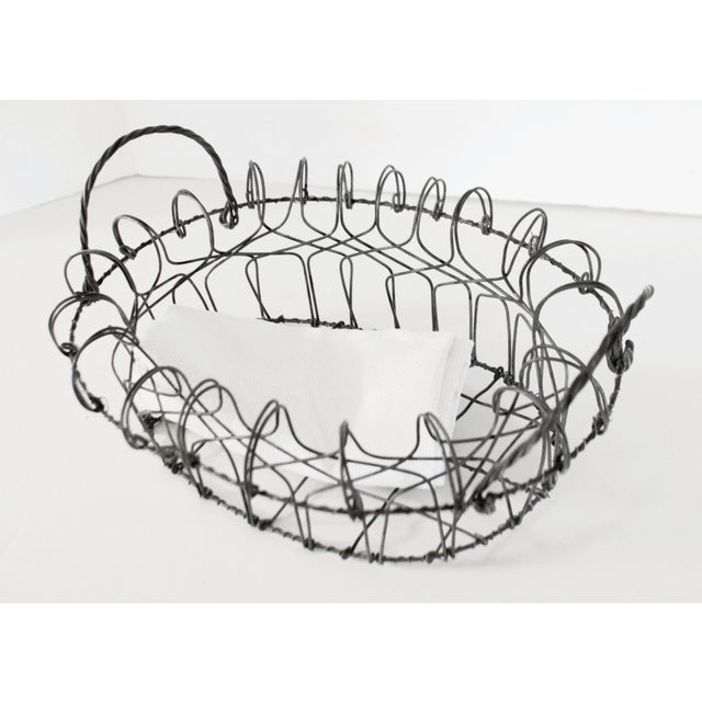 Made in France during the early to mid 1900s, this bread basket features a durable hand-wrapped frame with swing handles....